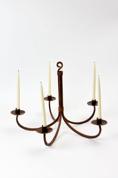 a small candelabra with five candles in the shape of an eight - arm candle holder