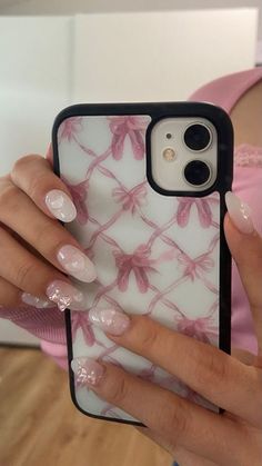 a woman is holding her phone case with flowers on it