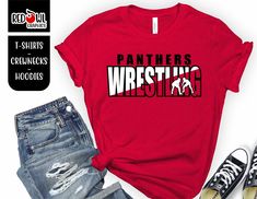 a red shirt with the words panther wrestling on it next to ripped jeans and sneakers