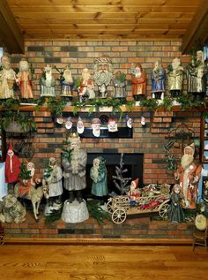 a fireplace decorated with christmas decorations and figurines