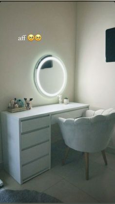 a white chair sitting in front of a desk with a mirror on it