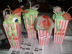 three cupcakes with green frosting and googly eyes are on the table