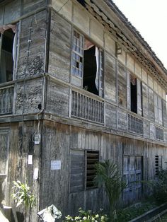 an old wooden building with windows and balconies