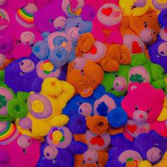 a pile of colorful teddy bears sitting next to each other