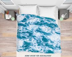 an aerial view of a bed with blue ocean waves on it and the words home decor for bathers written in black ink