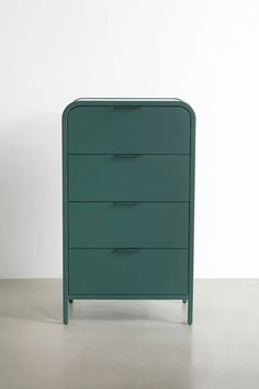 a green chest of drawers sitting on top of a floor