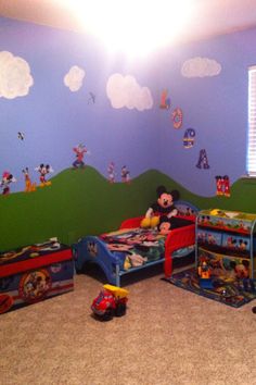 a mickey mouse themed bedroom with blue walls and carpeted flooring is pictured in this image