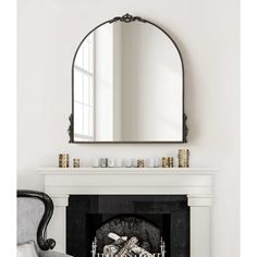 a fireplace with a mirror above it