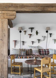 a living room filled with lots of furniture next to a wall mounted deer head on the wall