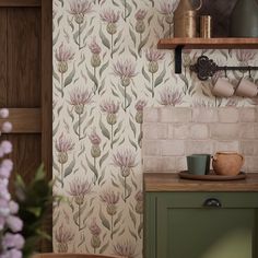 a kitchen wallpaper with pink flowers and green cupboards next to a brick wall