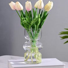 a vase filled with flowers sitting on top of a table