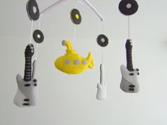 a mobile with musical instruments hanging from it's sides in the shape of guitars