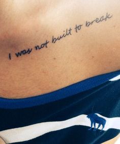 a woman with a tattoo on her stomach saying i was not built to break