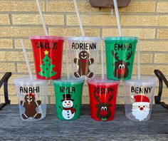 christmas themed cups with names on them and santa's sleigh, reindeer, snowman