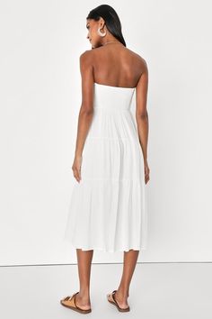 It's easy to fall in love with your reflection when you're wearing the Lulus Sweetness and Sunshine White Strapless Midi Dress With Pockets! Lightweight woven fabric shapes this essential summer dress that has a strapless bodice (with hidden no-slip strips) and a seamed bodice. High waist tops a tiered skirt (with side seam pockets) that features a decorative button placket, running from the neckline to the midi hem. Smocked panel at back for fit. Fit: This garment fits true to size. Length: Mid Feminine Summer Strapless Dress For Vacation, Feminine Strapless Summer Dress For Vacation, Feminine Strapless Dress For Summer Brunch, Feminine Strapless Mini Dress For Summer, Sundress Beach Dress Midi Length For Daywear, Sundress Beach Dress Midi Length, Fitted Bandeau Midi Dress For The Beach, Feminine Summer Maxi Dress With Smocked Back, Daywear Beach Sundress In Midi Length