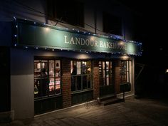 the outside of a restaurant lit up at night