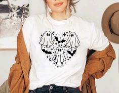 a woman wearing a t - shirt with two ghost heads in the shape of a heart