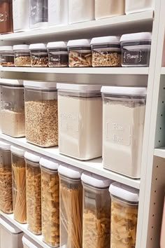 the shelves are filled with many different types of cereals and pasta in plastic containers