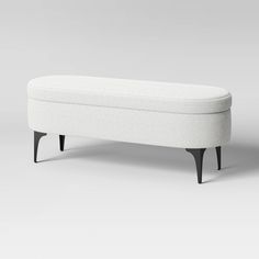 a white bench sitting on top of a gray floor