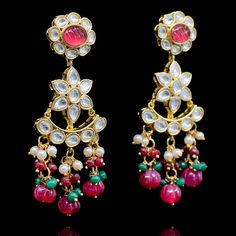 Crafting timeless masterpieces to perfection for eternity! Statement heritage earrings created with kundan stones and beautiful ruby beads. Approximate earrings length is 1.75". Gold-plated on high-quality brass as base metal. In-stock & ready-to-ship. *Please Note: We use faux stones and beads in all of our jewelry. Red Kundan Chandbalis In Fusion Style, Red Earrings For Diwali Rituals, Fusion Style Jeweled Kundan Danglers, Heavy Kundan Fusion Earrings, Festive Jeweled Chandbali Earrings, Jeweled Pearl Earrings For Festivals, Jeweled Pearl Earrings For Festive Occasions, Festive Bridal Earrings With Meenakari And Ruby, Festive Bridal Ruby Earrings With Meenakari