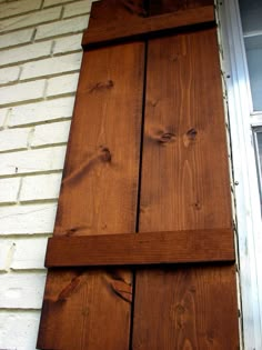 a close up of the side of a house with wood siding and window sill