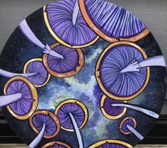 a plate with purple and orange designs on it sitting next to a window sill