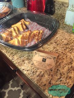 some food is sitting on top of a counter next to a sign that says toasty bread