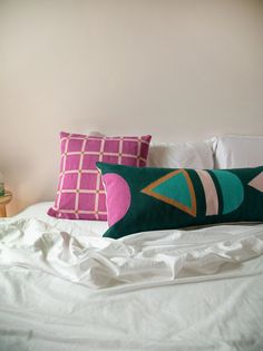 a bed with two pillows on top of it