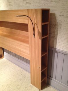 a wooden bunk bed with built - in bookshelves and shelves on the wall