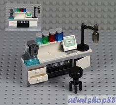 there is a lego workbench with many items on the desk and in front of it