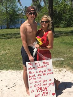 a man and woman standing next to each other holding a sign that says, this is only thing more beautiful than a day at the beach