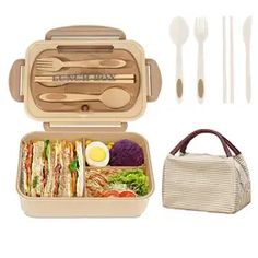 an open lunch box with utensils and food in it