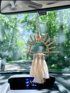 a car dashboard with a sun - shaped decoration hanging from it's windshield