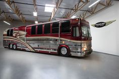 a large red bus parked in a garage