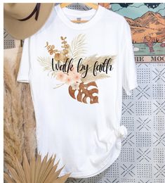 Are you looking for a fun way to share your faith? Look no further than Walk by Faith Walk with Jesus womens graphic tee shirt, Womens boho scripture shirt, Boho graphic bible verse sweatshirt for women her and, Comfort Colors introduces the "Comfort Colors 1717" garment-dyed t-shirt; a fully customizable tee made 100% with ring-spun cotton. The soft-washed, garment-dyed fabric brings extra coziness to your wardrobe while the relaxed fit makes it an excellent daily choice. The double-needle stitching throughout the tee makes it highly durable while the lack of side-seams helps the shirt retain its tubular shape. Discover all 58 colors in our Comfort Colors 1717 color charts below. .: The Comfort Colors 1717 tee is made with medium fabric (6.1 oz/yd² (206.8 g/m consisting of high quality, 1 White Bohemian T-shirt For Vacation, Bohemian Graphic Print T-shirt For Vacation, Bohemian Relaxed Fit T-shirt With Letter Print, Bohemian White T-shirt With Graphic Print, White Bohemian T-shirt With Graphic Print, White Bohemian T-shirt With Letter Print, Boho Scripture, Walk With Jesus, Womens Graphic Tee