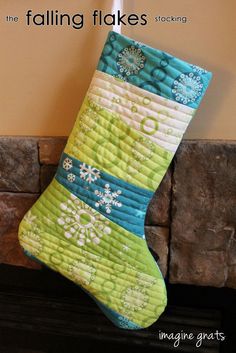 a christmas stocking hanging on a fireplace with the words falling flakes written below it