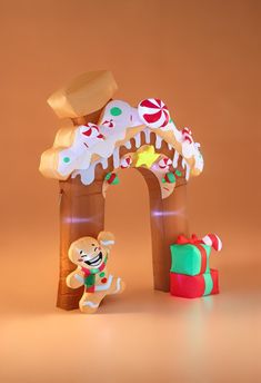 a gingerbread house is decorated with icing and decorations for the holiday season,