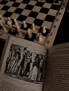 an open book sitting on top of a chess board