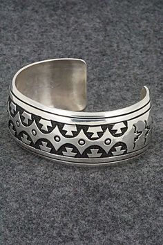 This sterling silver bracelet was made by Navajo silversmith Rosita Singer. The back is signed T&R Singer and stamped sterling.Size: 5 1/2" (will fit a 6 3/4" wrist)Gap: 1 1/4"Length: 1"Free shipping on all orders! We ship with USPS and always include tracking. All orders ship within a day of payment.Returns are accepted up to 30 days after you receive your order. Just send us a message. Our shop offers cash back or store credit. The item must be returned in new condition. Southwestern Style 925 Silver Bracelets, Handmade Southwestern Silver Bracelets, Southwestern Style Stamped Sterling Silver Bangle, Southwestern Style Stamped Sterling Silver Bangle Bracelet, Silver Southwestern Stamped Bracelets, Southwestern Stamped Silver Bracelets, Sterling Silver Southwestern Bracelet, Southwestern Sterling Silver Stamped Bangle Bracelet, Silver Stamped Southwestern Bracelets