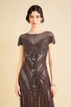 The intricate beadwork creates a mesmerizing pattern across the bodice, with artfully placed sequins that shimmer like stars in a midnight sky. This geometric design captures the bold spirit of the Jazz Age, while the cascading fringe along the hemline adds dynamic energy to your every move, evoking the carefree and exuberant vibes of a 1920s speakeasy. Features: Intricate geometric beadwork Elegant V-neckline Asymmetrical fringe hemline Figure-flattering silhouette Handcrafted sequin embellishments Great stretch 100% polyester fabric Kate, standing at 5 feet 8.9 inches, wears a size 2 in BABEYOND. Her measurements are 30.7" bust, 23.6" waist, and 34.3" hips. Note: This dress comes with an unique size chart. Be sure to select your ideal fit from the chart before making your purchase. Fitted Beaded Evening Dress For Festive Occasions, Fitted Sequin Embellished Fabric For Evening, Festive Dress With Sequins And Fitted Bodice, Fitted Banquet Dress With Contrast Sequin, Embellished Sequin Fabric For Evening Dress And Festive Occasions, Embellished Sequin Fabric For Festive Evening Dresses, Festive Embellished Sequin Fabric For Evening Dresses, Fitted Sequined Evening Dress For Festive Occasions, Festive Fitted Sequin Dress For Banquet