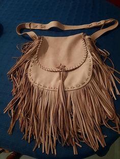 Soft leather, fringed 12" x 13" x 4" bag with 9"- long fringe. Large front pocket. Interior pocket with smaller, expandable pocket. Strong, double 54" strap (46" without attached sides). Leather lacing and waxed sinew stitches. Rolled leather button and tassel. A Northwoods Leathers creation. Leather Fringe Bag, Leather Lacing, Long Fringe, Fringe Bags, Long Fringes, Leather Fringe, Leather Bags, Leather And Lace, Cross Body Handbags