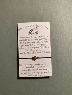 a bracelet with a message attached to it sitting on top of a card that says, cause from a sea turtle