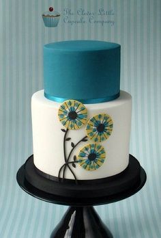 a white and blue cake with flowers on it