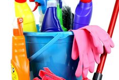 a bucket filled with cleaning supplies and gloves on top of a white surface, next to a pair of red rubber gloves