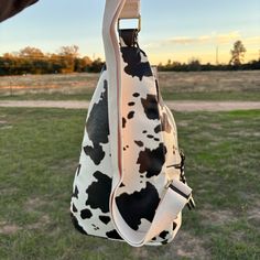 Two compartments, multiple pockets, and an adjustable strap for extra comfort. Faux leather. Dimensions: 7.5"L x 3"W x 13"H John 15 5, Bagpack, Cow Print, Sling Bag, Cow, Adjustable Straps, Faux Leather, Leather