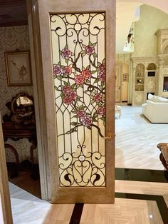 an ornate glass door with pink flowers on it