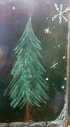 a chalk drawing of a christmas tree with snowflakes on it's side