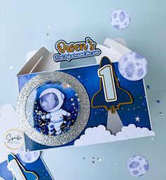 a blue and white space themed birthday card with an astronaut's plate on it