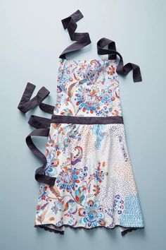 an image of a dress with black ribbon on the back and blue floral print design