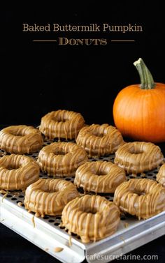 there are many peanut butter cookies on the cooling rack next to an orange pumpkin and black background